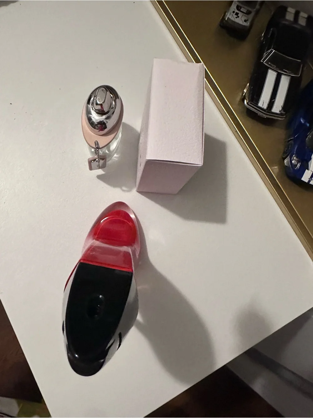 Empty Carolina Herrera Red and Black Stiletto and Coach Bottles
